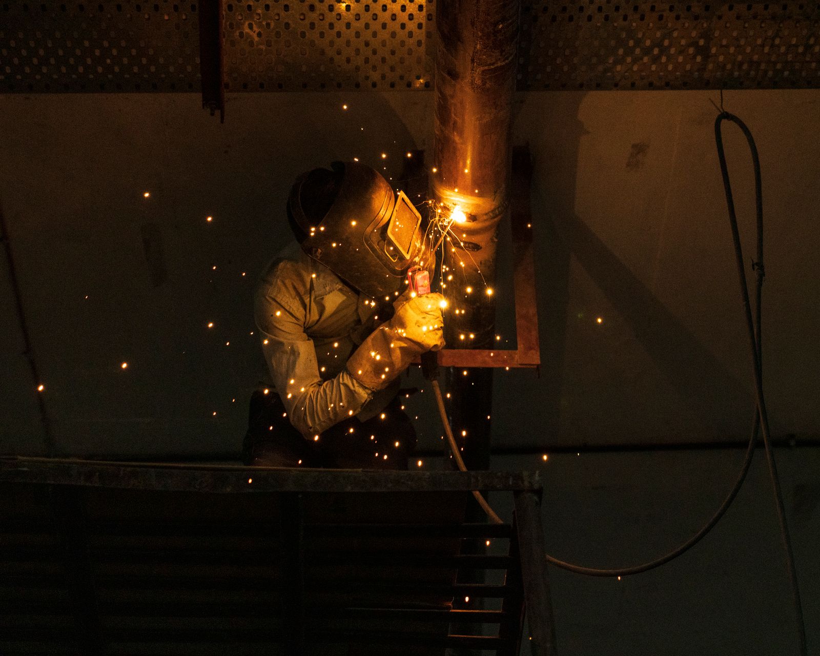 Welder qualifying a pipe weld